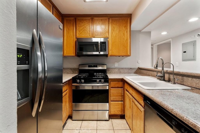 5325 Newcastle Ave Unit 319, Encino, CA 91316 - kitchen with appliances with stainless steel finishes, electric panel, brown cabinets, light tile patterned floors, and recessed lighting