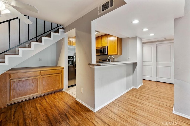 5325 Newcastle Ave Unit 319, Encino, CA 91316 - kitchen with stainless steel appliances, light wood-type flooring, recessed lighting, a ceiling fan, and brown cabinetry