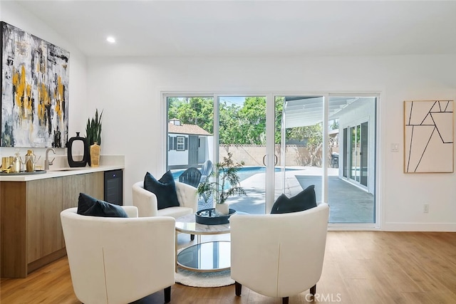 4701 Deseret Dr, Woodland Hills, CA 91364 - dining area featuring healthy amount of natural light, light wood-style flooring, wine cooler, and recessed lighting