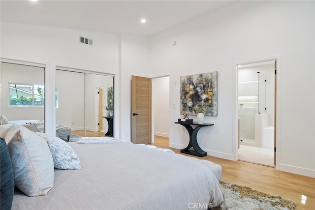 4701 Deseret Dr, Woodland Hills, CA 91364 - bedroom featuring wood finished floors, multiple closets, recessed lighting, high vaulted ceiling, and ensuite bathroom