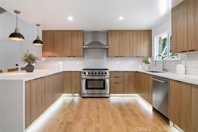4701 Deseret Dr, Woodland Hills, CA 91364 - kitchen with wall chimney range hood, appliances with stainless steel finishes, modern cabinets, light wood-type flooring, and light countertops