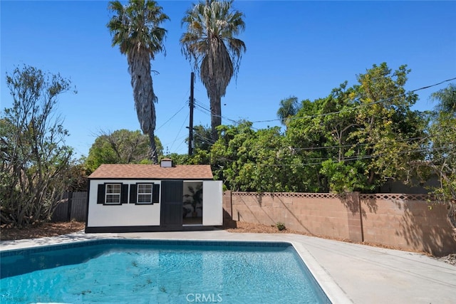 4701 Deseret Dr, Woodland Hills, CA 91364 - view of swimming pool featuring an outdoor structure, a fenced backyard, and an exterior structure