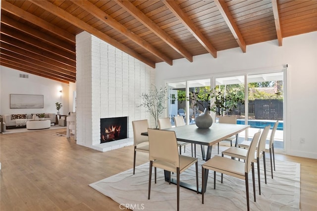 4701 Deseret Dr, Woodland Hills, CA 91364 - dining room with light wood-style floors, a brick fireplace, a wood ceiling with exposed beams, and high vaulted ceiling