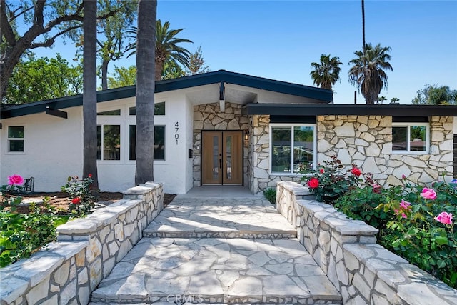 4701 Deseret Dr, Woodland Hills, CA 91364 - property entrance featuring french doors, stone siding, and stucco siding