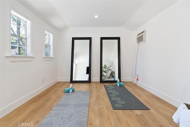 4701 Deseret Dr, Woodland Hills, CA 91364 - workout room featuring a wall mounted AC, wood finished floors, and lofted ceiling