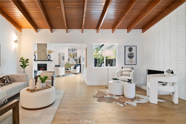 4701 Deseret Dr, Woodland Hills, CA 91364 - living room featuring a warm lit fireplace, light wood-style floors, and wooden ceiling