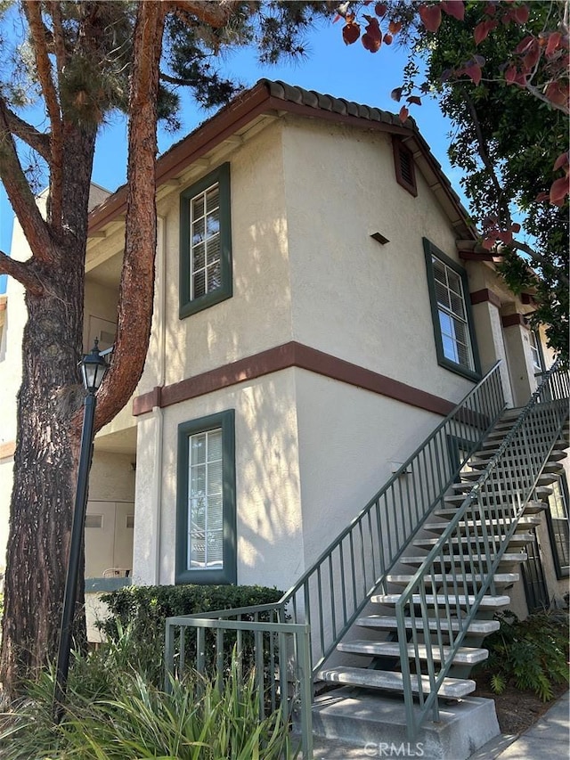 10824 Sabre Hill Dr Unit 194, San Diego, CA 92128 - view of home's exterior featuring stairs and stucco siding