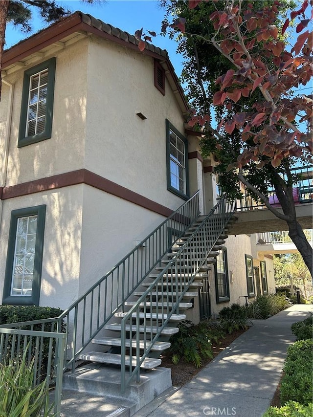 10824 Sabre Hill Dr Unit 194, San Diego, CA 92128 - view of side of property with stairs and stucco siding