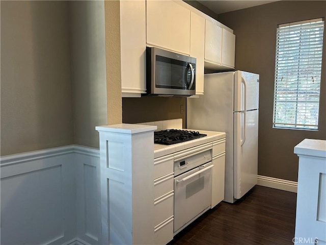 10824 Sabre Hill Dr Unit 194, San Diego, CA 92128 - kitchen featuring white appliances, dark wood finished floors, white cabinetry, a wainscoted wall, and tile counters