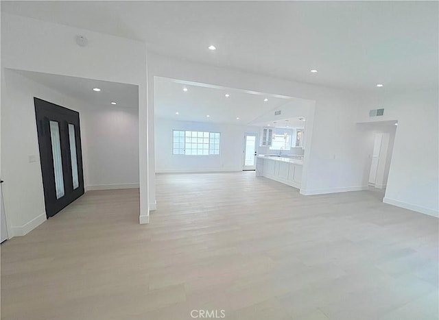 21541 Yucatan Ave, Woodland Hills, CA 91364 - unfurnished living room with light wood finished floors and recessed lighting