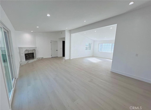 21541 Yucatan Ave, Woodland Hills, CA 91364 - unfurnished living room with recessed lighting, light wood-style flooring, and a fireplace