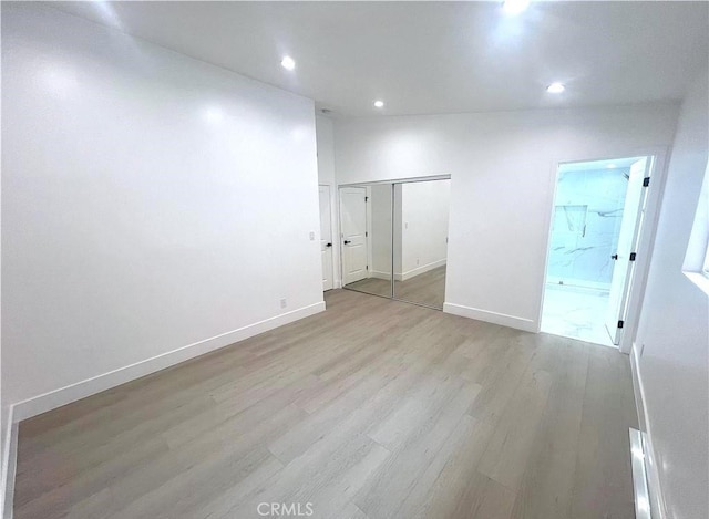 21541 Yucatan Ave, Woodland Hills, CA 91364 - unfurnished bedroom with light wood finished floors, recessed lighting, a closet, and ensuite bathroom