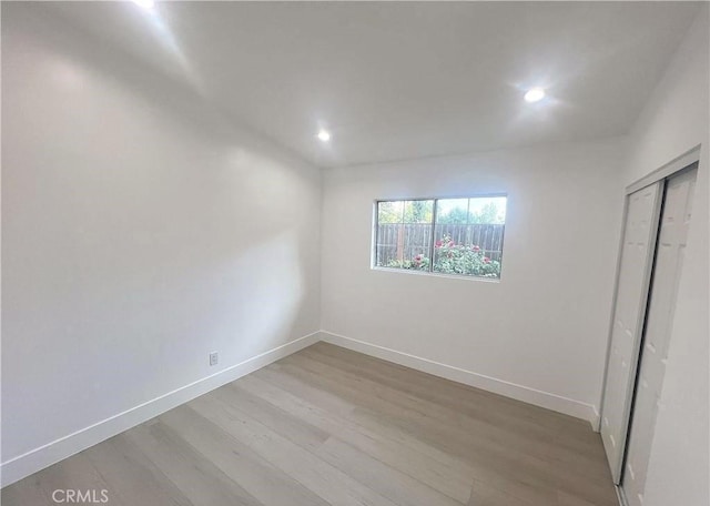21541 Yucatan Ave, Woodland Hills, CA 91364 - unfurnished bedroom with light wood-style flooring, recessed lighting, and a closet