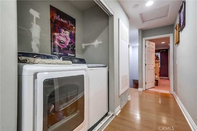 2975 Fernwood Ave, Lynwood, CA 90262 - laundry area with light wood finished floors, separate washer and dryer, and attic access