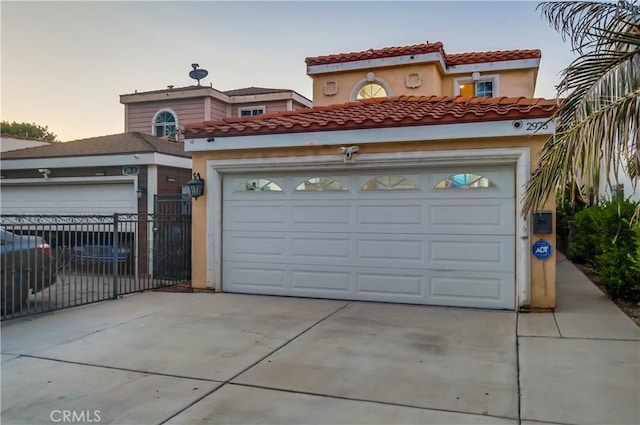 2975 Fernwood Ave, Lynwood, CA 90262 - mediterranean / spanish house with stucco siding, concrete driveway, and a tiled roof