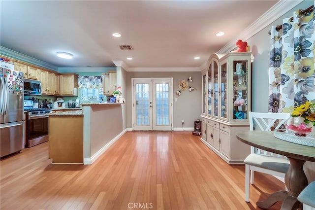 2975 Fernwood Ave, Lynwood, CA 90262 - kitchen with stainless steel appliances, light wood-style floors, ornamental molding, a peninsula, and recessed lighting