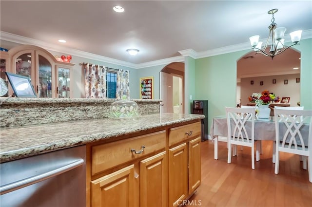 2975 Fernwood Ave, Lynwood, CA 90262 - kitchen featuring arched walkways, ornamental molding, light wood finished floors, a chandelier, and light stone counters