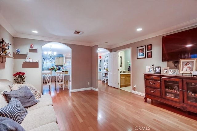 2975 Fernwood Ave, Lynwood, CA 90262 - living room with arched walkways, wood finished floors, a chandelier, recessed lighting, and ornamental molding