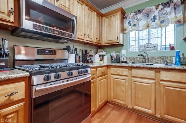 2975 Fernwood Ave, Lynwood, CA 90262 - kitchen with appliances with stainless steel finishes, light wood-type flooring, light stone countertops, and light brown cabinets