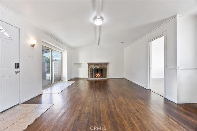 9720 Live Oak Ave, Temple City, CA 91780 - unfurnished living room with lofted ceiling, wood finished floors, and a lit fireplace