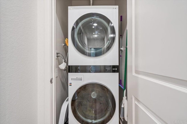2013 Bravo Loop Unit 2, Chula Vista, CA 91915 - laundry room featuring stacked washer and clothes dryer and a textured wall