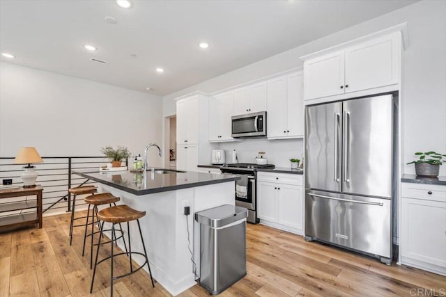 2013 Bravo Loop Unit 2, Chula Vista, CA 91915 - kitchen featuring stainless steel appliances, dark countertops, light wood-type flooring, and recessed lighting
