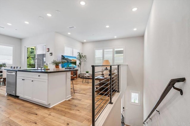 2013 Bravo Loop Unit 2, Chula Vista, CA 91915 - kitchen with dark countertops, white cabinets, healthy amount of natural light, light wood-type flooring, and recessed lighting