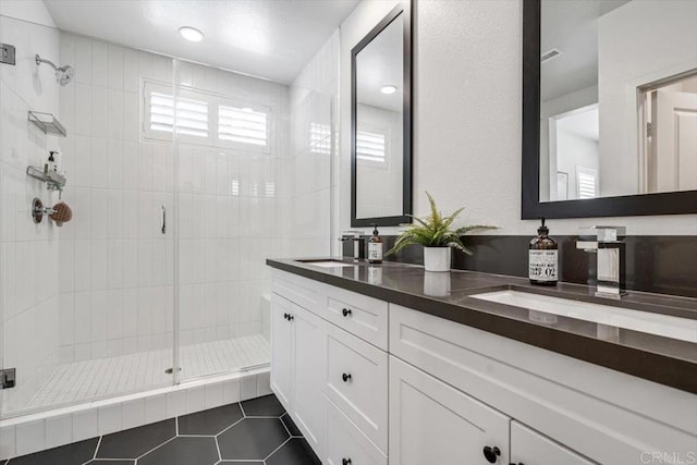2013 Bravo Loop Unit 2, Chula Vista, CA 91915 - bathroom featuring tile patterned floors, a stall shower, and double vanity
