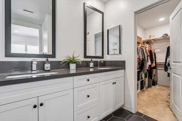 2013 Bravo Loop Unit 2, Chula Vista, CA 91915 - bathroom featuring double vanity, a spacious closet, and tile patterned floors