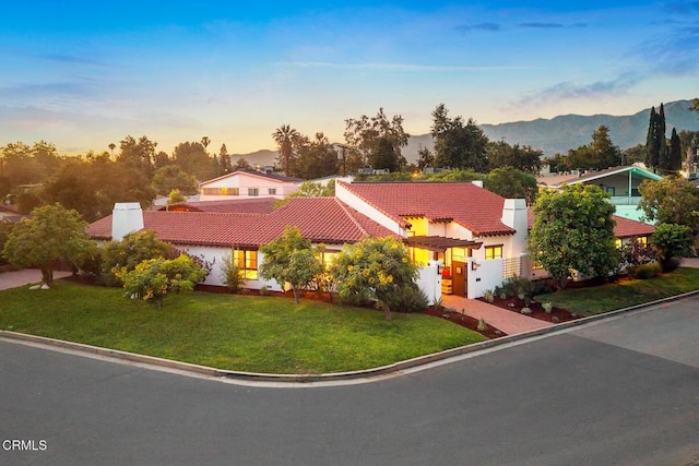 1533 Rancho Ave, Glendale, CA 91201 - mediterranean / spanish home featuring a tiled roof, driveway, a yard, stucco siding, and a mountain view