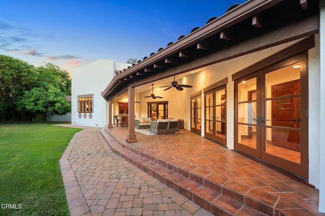 1533 Rancho Ave, Glendale, CA 91201 - patio terrace at dusk with french doors, a patio area, a yard, an outdoor living space, and a ceiling fan
