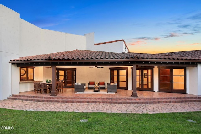 1533 Rancho Ave, Glendale, CA 91201 - back of property at dusk featuring a ceiling fan, an outdoor hangout area, a patio area, stucco siding, and a tiled roof