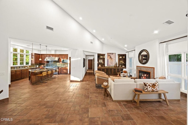 1533 Rancho Ave, Glendale, CA 91201 - living room featuring a fireplace, stone tile floors, recessed lighting, and high vaulted ceiling