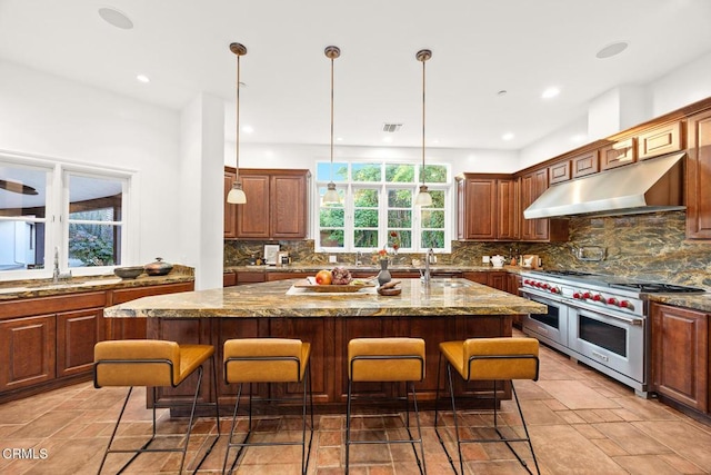 1533 Rancho Ave, Glendale, CA 91201 - kitchen featuring double oven range, under cabinet range hood, a breakfast bar area, decorative backsplash, and recessed lighting