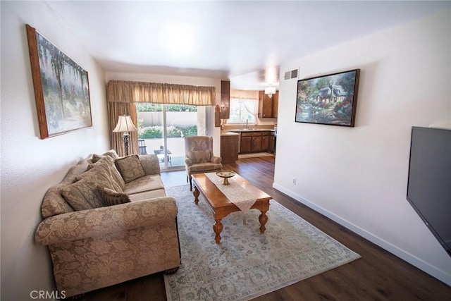 20716 Community St, Winnetka, CA 91306 - living area featuring dark wood-type flooring and baseboards