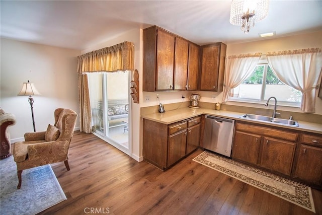 20716 Community St, Winnetka, CA 91306 - kitchen featuring dishwasher, wood finished floors, light countertops, and brown cabinets