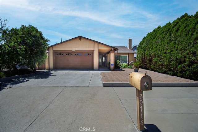 20716 Community St, Winnetka, CA 91306 - ranch-style house featuring concrete driveway, a garage, and stucco siding