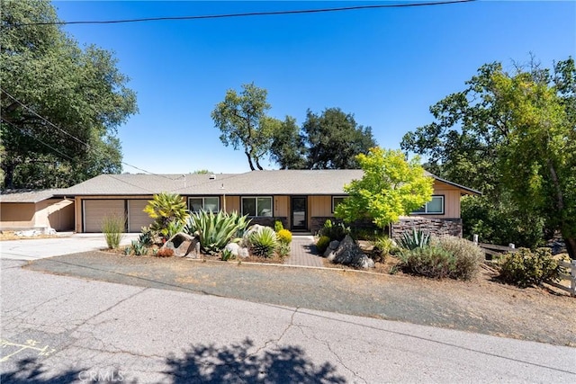 5155 Ardilla Ave, Atascadero, CA 93422 - ranch-style home with stone siding, an attached garage, and driveway