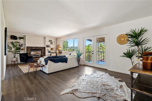 5155 Ardilla Ave, Atascadero, CA 93422 - living area featuring french doors, dark wood-style flooring, and a stone fireplace