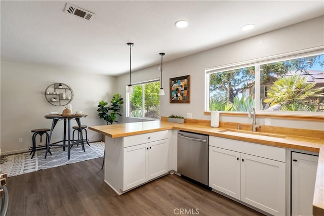 5155 Ardilla Ave, Atascadero, CA 93422 - kitchen with butcher block countertops, dishwasher, a peninsula, white cabinetry, and recessed lighting