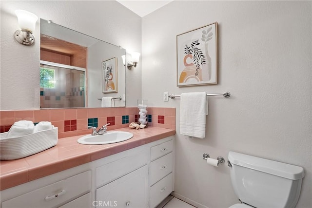 5155 Ardilla Ave, Atascadero, CA 93422 - bathroom with vanity, a shower with shower door, and decorative backsplash