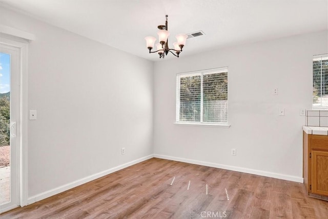 4729 Lookout Mountain Rd, Mariposa, CA 95338 - unfurnished dining area featuring light wood-type flooring and a chandelier