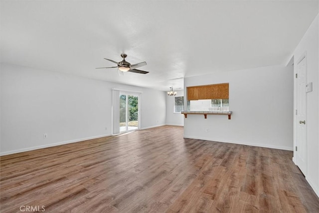 4729 Lookout Mountain Rd, Mariposa, CA 95338 - unfurnished living room with a ceiling fan, wood finished floors, and a chandelier