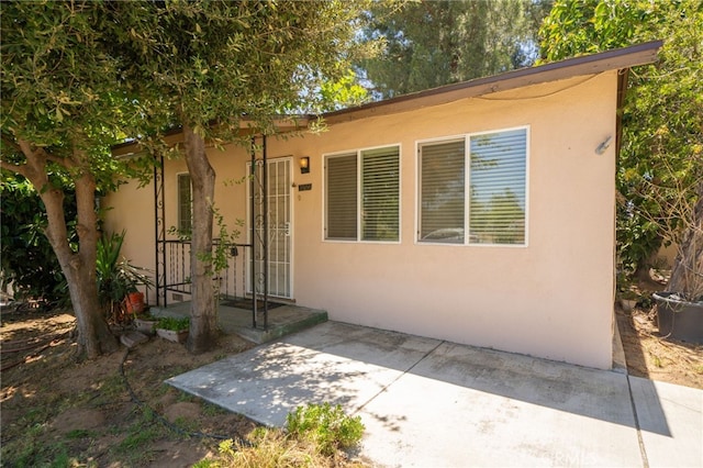 3986 Tomlinson, Riverside, CA 92503 - doorway to property with stucco siding and a patio area