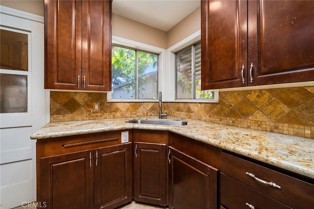3986 Tomlinson, Riverside, CA 92503 - kitchen featuring light stone counters, tasteful backsplash, and dark brown cabinetry