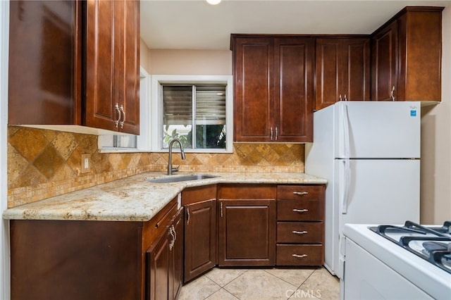 3986 Tomlinson, Riverside, CA 92503 - kitchen featuring backsplash, light stone countertops, gas range gas stove, light tile patterned flooring, and dark brown cabinets
