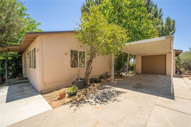 3986 Tomlinson, Riverside, CA 92503 - view of front facade featuring stucco siding, driveway, and a garage