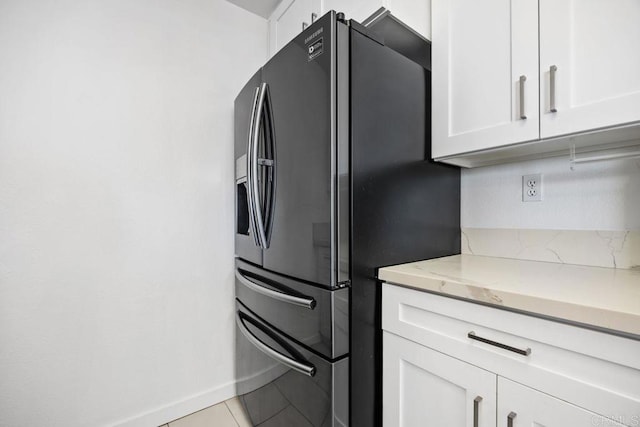 11375 Affinity Ct Unit 206, San Diego, CA 92131 - kitchen featuring black refrigerator with ice dispenser, white cabinets, light stone counters, and light tile patterned floors