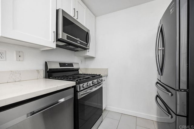 11375 Affinity Ct Unit 206, San Diego, CA 92131 - kitchen featuring stainless steel appliances, white cabinets, light stone countertops, and light tile patterned floors