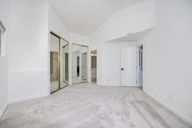 11375 Affinity Ct Unit 206, San Diego, CA 92131 - unfurnished bedroom featuring carpet flooring, multiple closets, vaulted ceiling, and ensuite bath